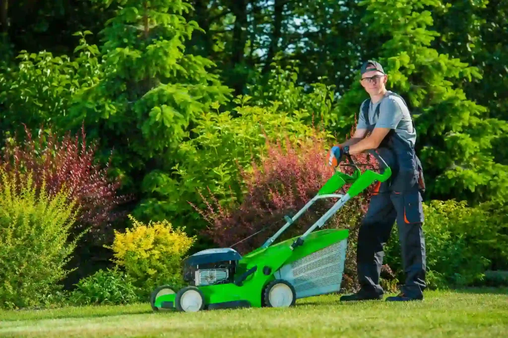 Gardener mowing lawn in a landscaped yard with modern equipment How Much Does Lawn Mowing Cost